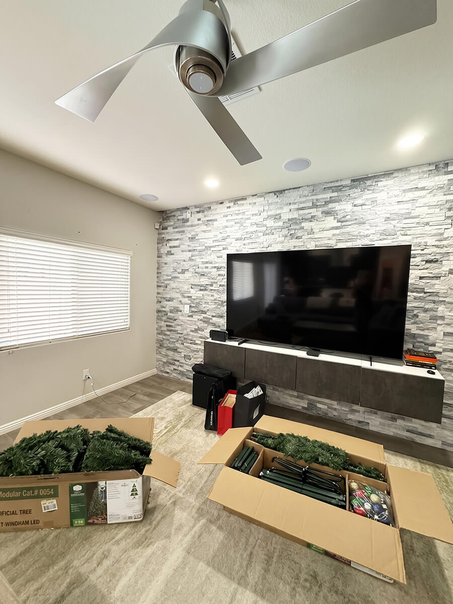Living room filled with unopened moving boxes before Lifelystyle move-in concierge unpacking in Las Vegas — furniture wrapped, art unhung