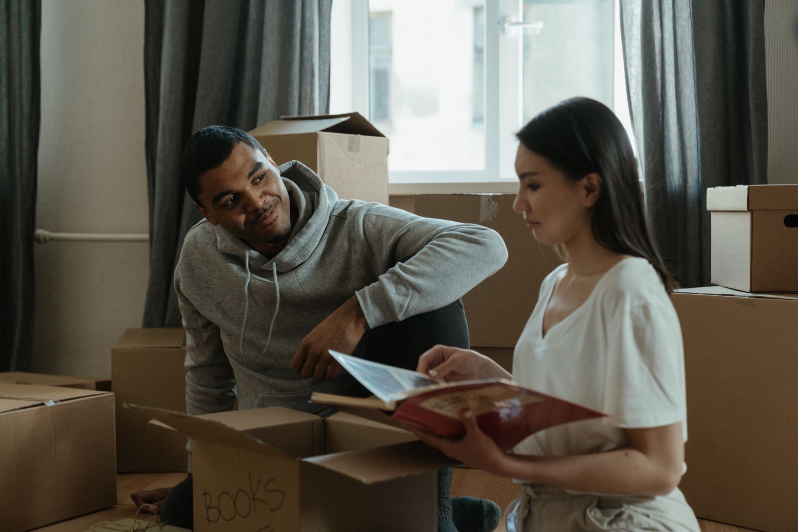 Couple unpacking moving boxes in their new home
