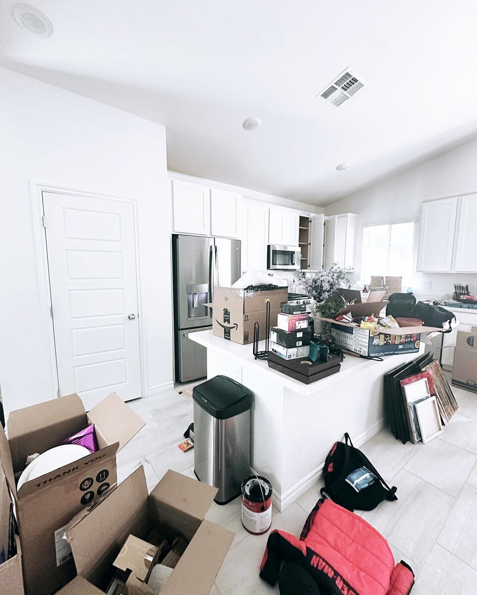 Stacked moving boxes covering a luxury kitchen counter before Lifelystyle move-in concierge unpacking in Las Vegas — overwhelming first-day chaos