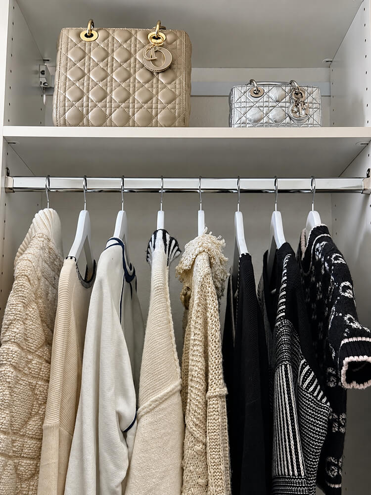 Luxury Dior Lady Dior handbags displayed on a custom closet shelf above neatly hung knitwear by Lifelystyle in Las Vegas — boutique-level wardrobe styling for high-end collections