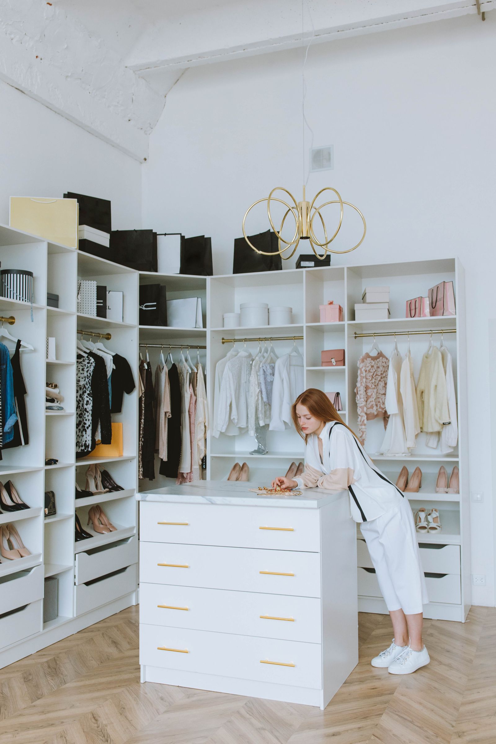 Organized luxury walk-in closet with neatly arranged clothing