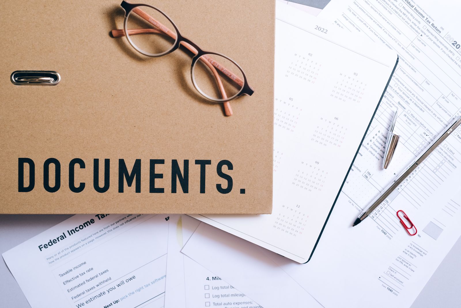 Organized tax documents and files folder on a home office desk