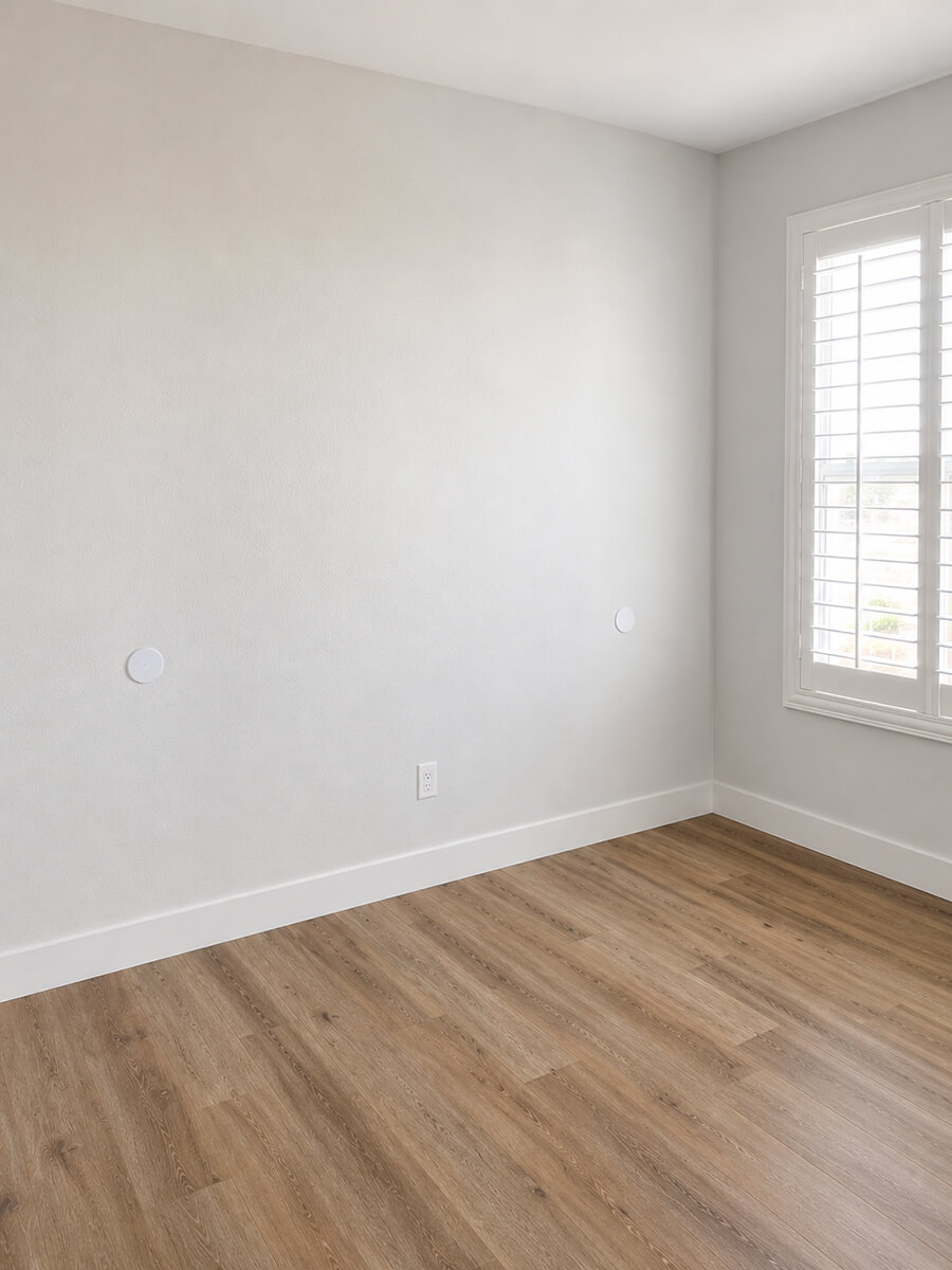 Completely empty room with bare white walls and hardwood floors before professional home staging by Lifelystyle in Las Vegas — a blank space that gives buyers no emotional connection or sense of purpose